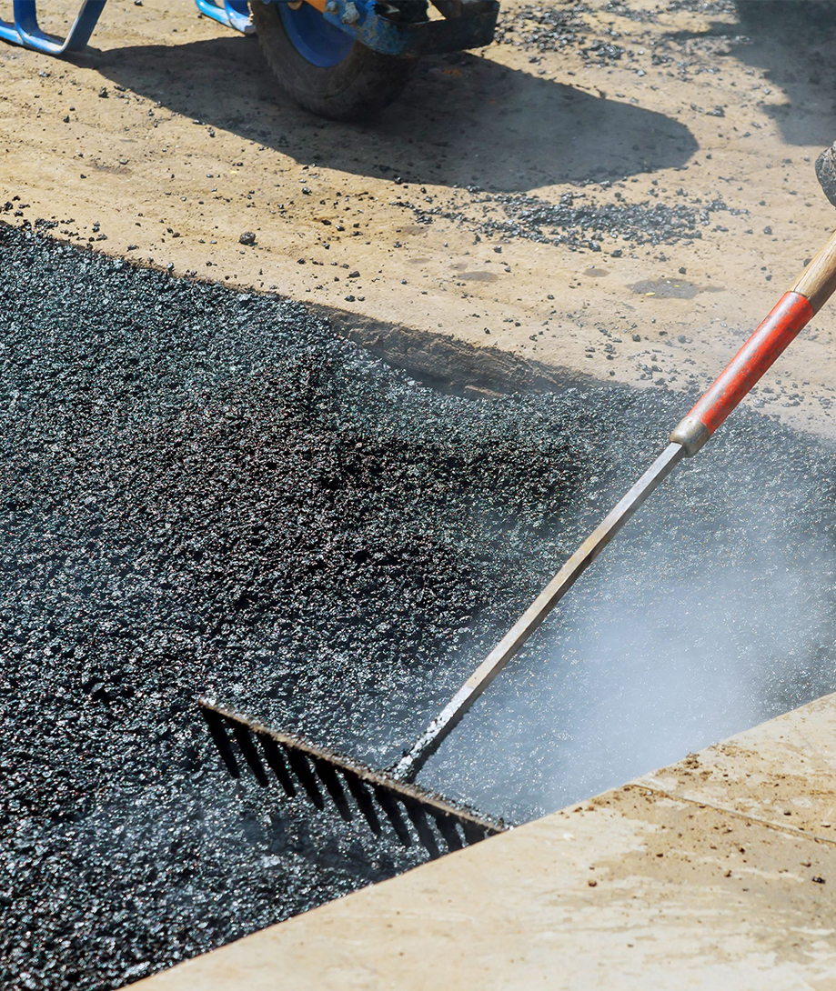 Raking asphalt during paving